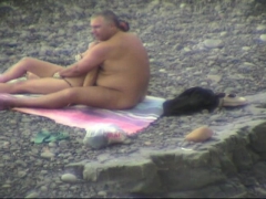 Pussy fingering of a MILF in a public nude beach