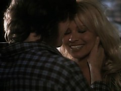 Pamela Anderson naked in a fireside love scene with a guy,